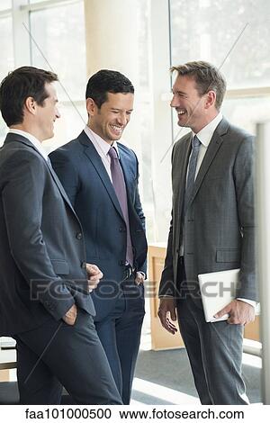 Stock Image - Businessmen having friendly conversation. Fotosearch
