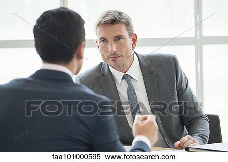 Businessmen in serious meeting View Large Photo Image Stock Photography - Businessmen in serious meeting. Fotosearch