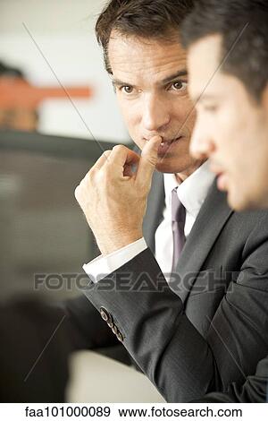 Stock Photo - Businessmen negotiating. Fotosearch