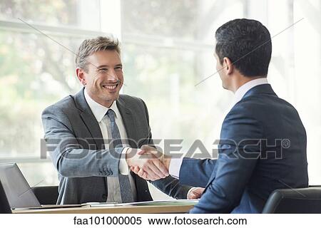 Businessmen shaking hands in meeting View Large Photo Image Stock Photography - Businessmen shaking hands in meeting. Fotosearch