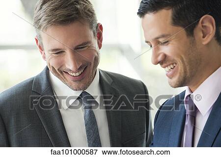 Businessmen talking and laughing together View Large Photo Image Stock Photo - Businessmen talking and laughing together. Fotosearch