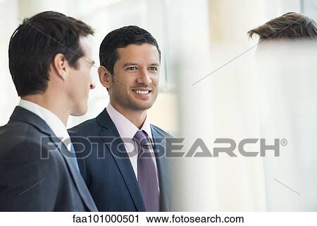Stock Image - Businessmen talking together. Fotosearch