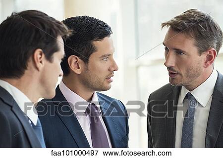 Stock Photo - Businessmen talking together. Fotosearch