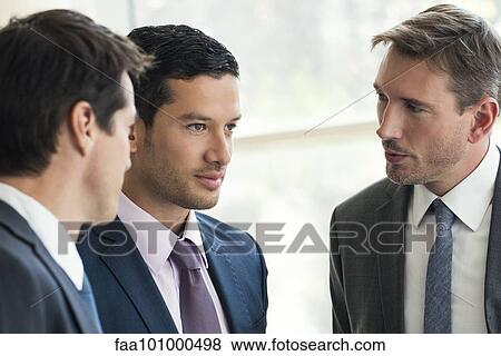 Stock Photo - Businessmen talking together. Fotosearch