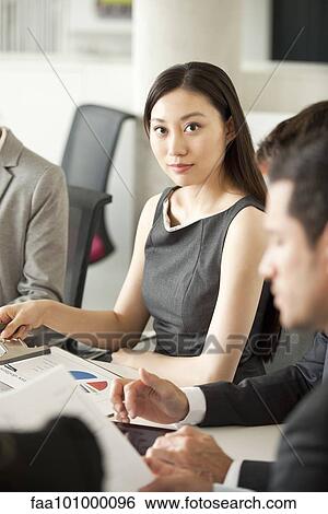 Businesswoman at corporate meeting View Large Photo Image Stock Photograph - Businesswoman at corporate meeting. Fotosearch