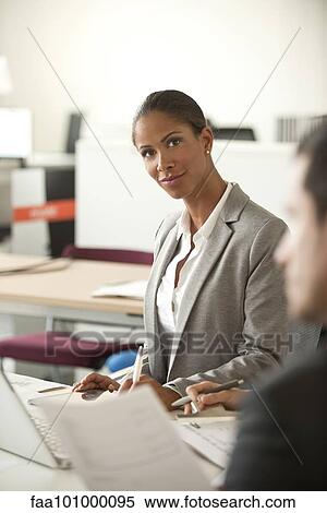 Businesswoman at corporate meeting View Large Photo Image Stock Photography - Businesswoman at corporate meeting. Fotosearch