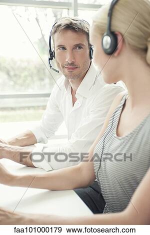 Call center workers chatting between calls View Large Photo Image Stock Photo - Call center workers chatting between calls. Fotosearch