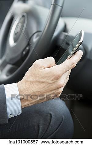 Cell phones can be dangerous distractions while driving View Large Photo Image Stock Photo - Cell phones can be dangerous distractions while driving. Fotosearch
