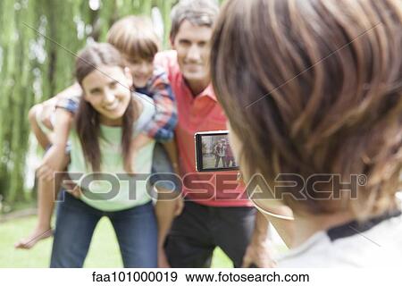 Child photographing his family View Large Photo Image Stock Photo - Child photographing his family. Fotosearch