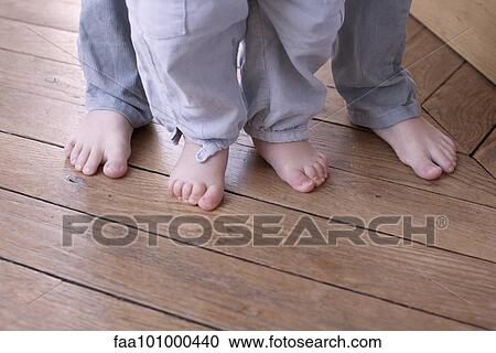 Close-up of child and baby's bare feet View Large Photo Image Stock Image - Close-up of child and baby's bare feet. Fotosearch