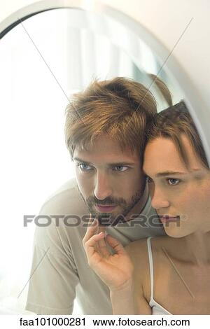 "Couple looking into mirror together, wife caressing husand's bearded chin" View Large Photo Image Stock Image - "Couple looking into mirror together, wife caressing husand's bearded chin". Fotosearch