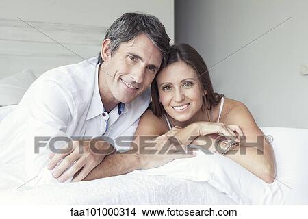 "Couple lying on bed, portrait" View Large Photo Image Picture - "Couple lying on bed, portrait". Fotosearch