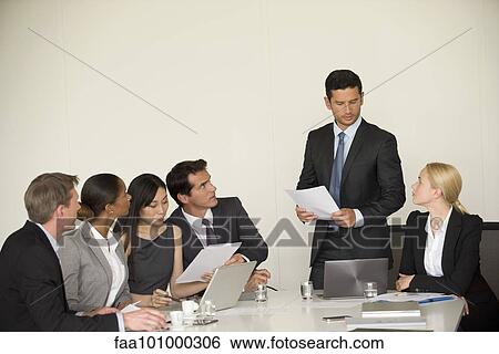 Stock Photograph - Executive giving presentation in meeting. Fotosearch