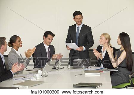 Executive receiving applause from colleagues during presentation View Large Photo Image Stock Image - Executive receiving applause from colleagues during presentation. Fotosearch