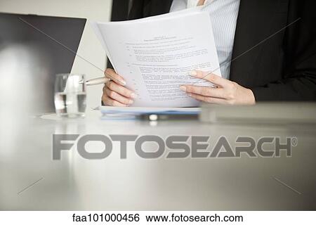 "Executive reviewing document, cropped" View Large Photo Image Stock Photograph - "Executive reviewing document, cropped". Fotosearch