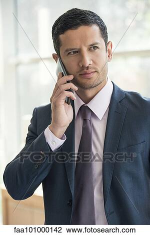 Stock Image - "Executive using cell phone, portrait". Fotosearch