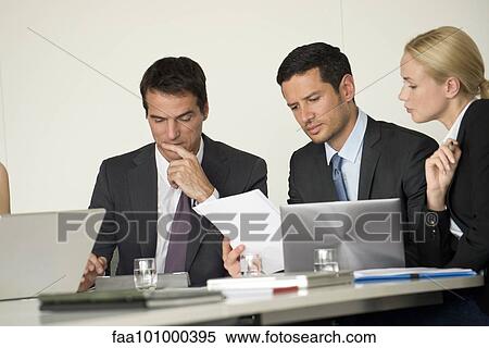 Stock Photography - Executives in meeting. Fotosearch