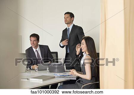 "Executives meeting in conference room, viewed through doorway" View Large Photo Image Stock Image - "Executives meeting in conference room, viewed through doorway". Fotosearch