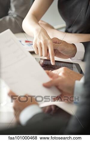 "Executives reviewing document in meeting, cropped" View Large Photo Image Stock Photo - "Executives reviewing document in meeting, cropped". Fotosearch