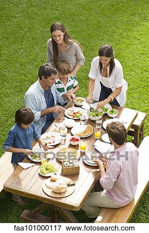 Family and friends enjoy healthy meal outdoors View Large Photo Image Stock Photo - Family and friends enjoy healthy meal outdoors. Fotosearch