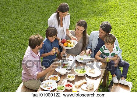 Stock Image - Family and friends gather for picnic. Fotosearch