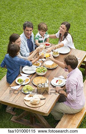 Stock Photography - Family and friends gather for picnic. Fotosearch