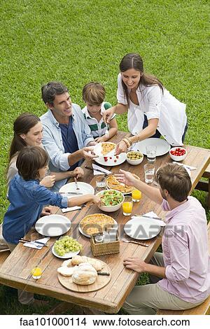 Picture - Family and friends having picnic while on vacation. Fotosearch