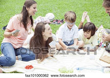 Family having picnic and playing card game View Large Photo Image Stock Image - Family having picnic and playing card game. Fotosearch