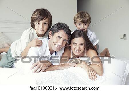 "Family lying on bed, portrait" View Large Photo Image Stock Photography - "Family lying on bed, portrait". Fotosearch