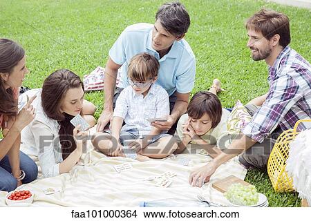Family playing card game at picnic View Large Photo Image Picture - Family playing card game at picnic. Fotosearch