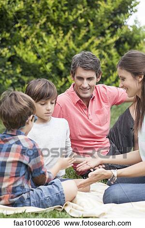Family playing hand games together at picnic View Large Photo Image Stock Photograph - Family playing hand games together at picnic. Fotosearch