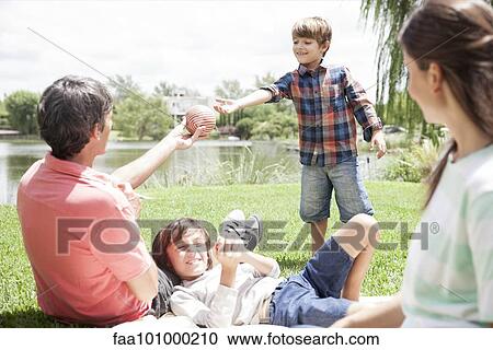 Father handing ball to young son View Large Photo Image Stock Image - Father handing ball to young son. Fotosearch