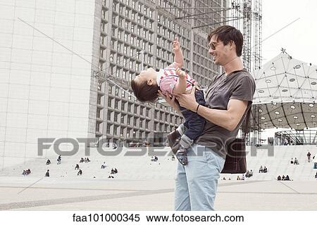Father playfully holding baby son View Large Photo Image Stock Photography - Father playfully holding baby son. Fotosearch