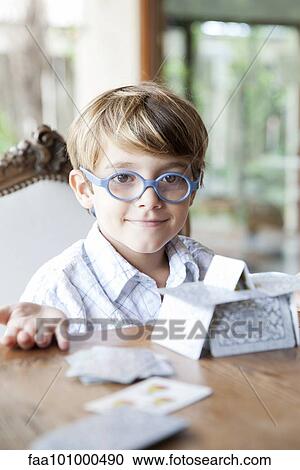 Little boy building house of cards View Large Photo Image Stock Image - Little boy building house of cards. Fotosearch