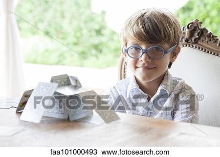 Little boy building house of cards View Large Photo Image Stock Image - Little boy building house of cards. Fotosearch