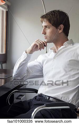 Man at desk contemplating View Large Photo Image Stock Photography - Man at desk contemplating. Fotosearch