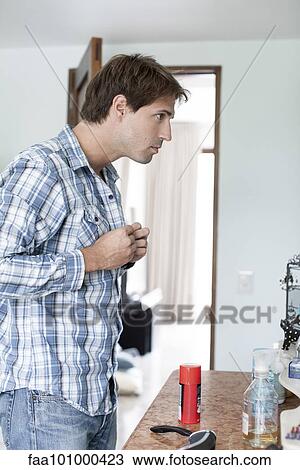 Man buttoning shirt View Large Photo Image Stock Image - Man buttoning shirt. Fotosearch