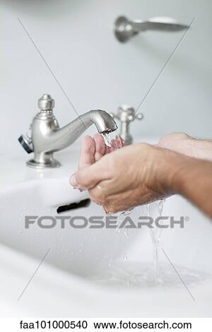 Man cupping hands beneath water running from bathroom faucet View Large Photo Image Stock Image - Man cupping hands beneath water running from bathroom faucet. Fotosearch