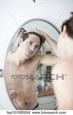 Man examining hairline in mirror View Large Photo Image Picture - Man examining hairline in mirror. Fotosearch