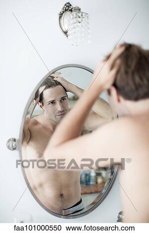 Man examining hairline in mirror View Large Photo Image Stock Image - Man examining hairline in mirror. Fotosearch
