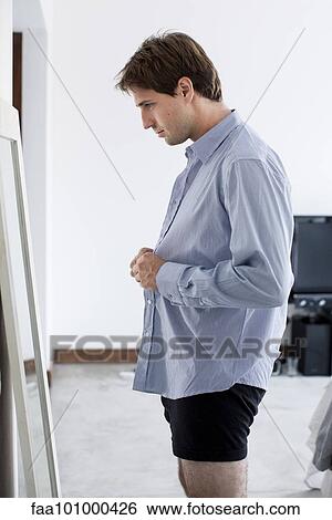 Man getting dressed View Large Photo Image Stock Photograph - Man getting dressed. Fotosearch