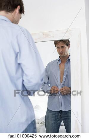 Stock Photography - Man getting dressed. Fotosearch