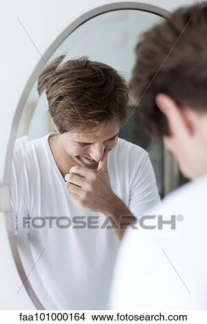 "Man laughing to self, reflection in mirror" View Large Photo Image Picture - "Man laughing to self, reflection in mirror". Fotosearch
