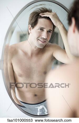 Man scrutinizing hairline in mirror View Large Photo Image Stock Image - Man scrutinizing hairline in mirror. Fotosearch