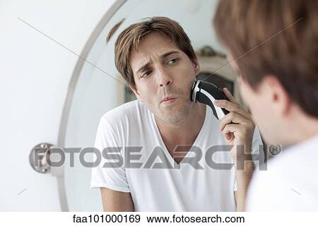Man shaving with electric razor View Large Photo Image Stock Photo - Man shaving with electric razor. Fotosearch