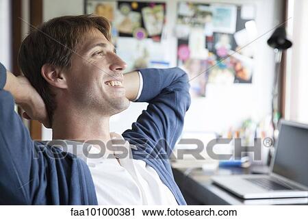 Man sitting in office daydreaming View Large Photo Image Stock Image - Man sitting in office daydreaming. Fotosearch