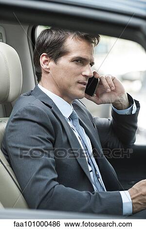 Man talking on cell phone while driving View Large Photo Image Stock Photograph - Man talking on cell phone while driving. Fotosearch