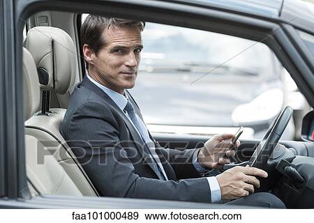 Man texting while driving car View Large Photo Image Stock Photo - Man texting while driving car. Fotosearch