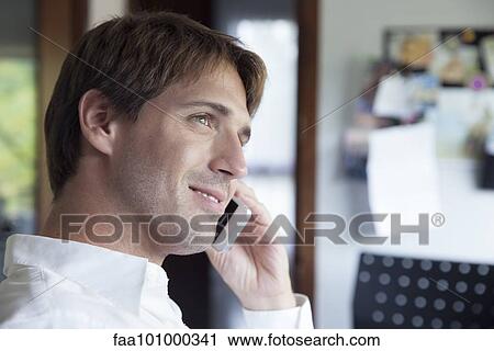 Stock Image - Man using cell phone. Fotosearch