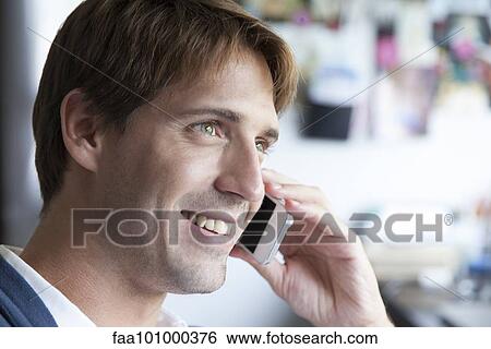 Stock Photograph - Man using cell phone. Fotosearch